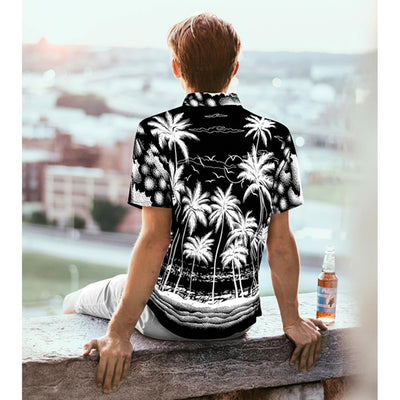 man having beer on rooftop in black and white hawaiian shirt with palm tree print