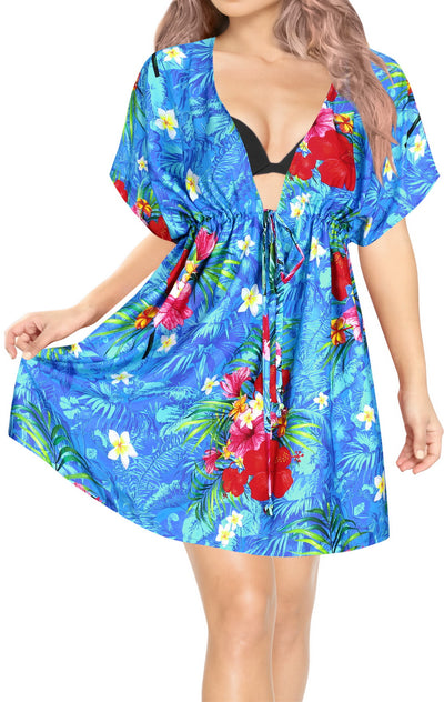 woman posing in short deep neck blue colored beach coverup with hawaiian tropical floral print