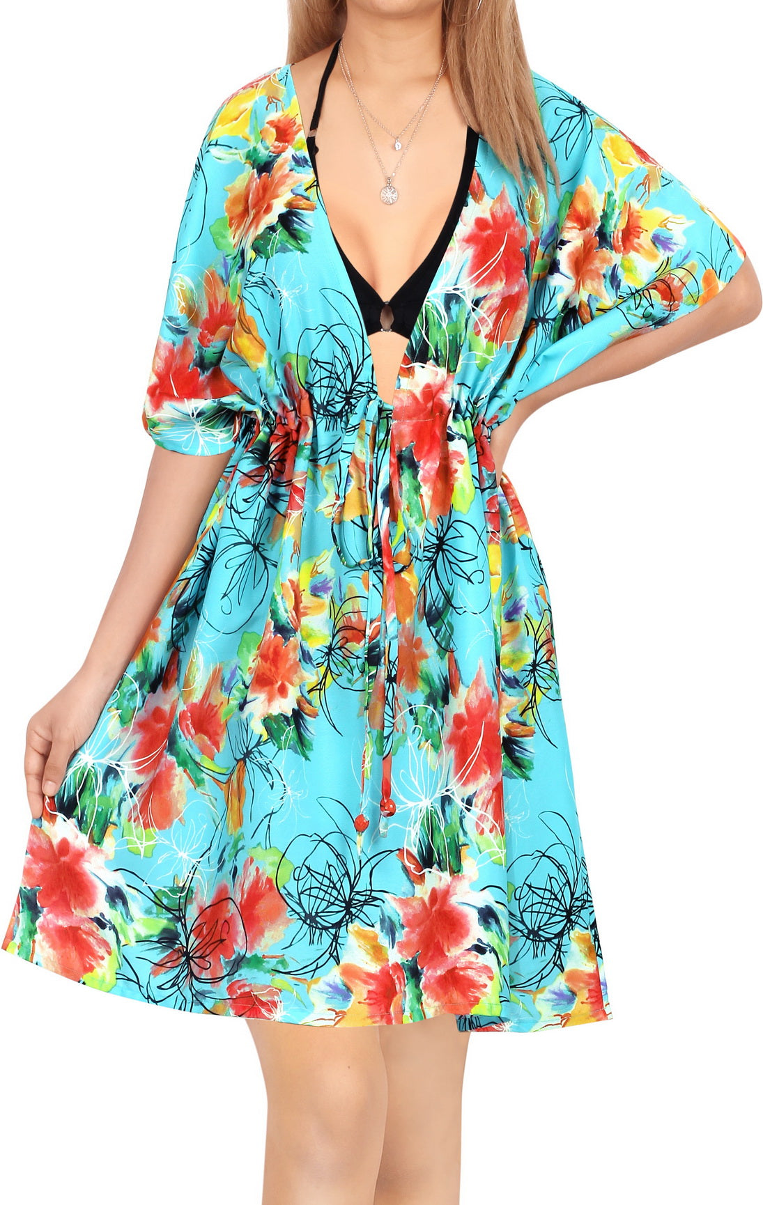 woman posing in deep v neck aqua colored coverup with hawaiian spring print
